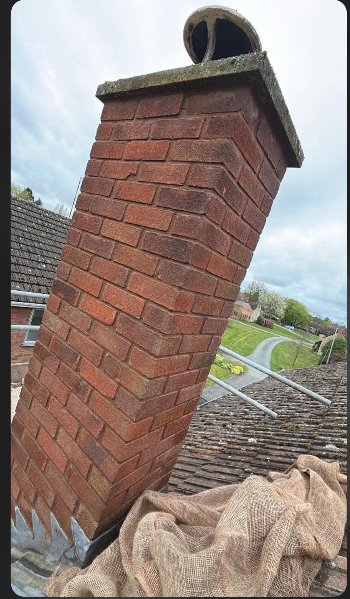 Rebuilt brick chimney stack with terracotta cowl